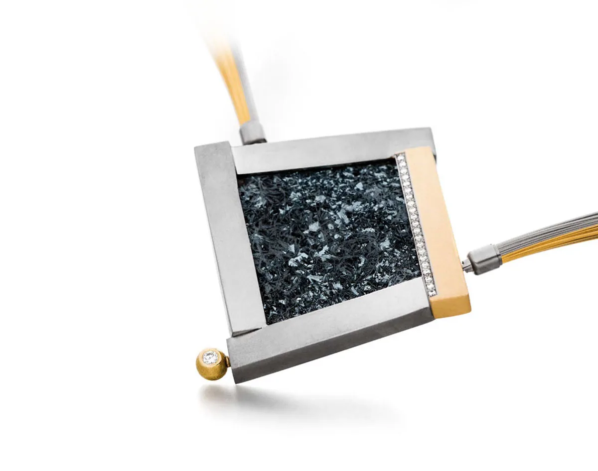 Rectangular pendant with dark stone, diamonds and gold edge
